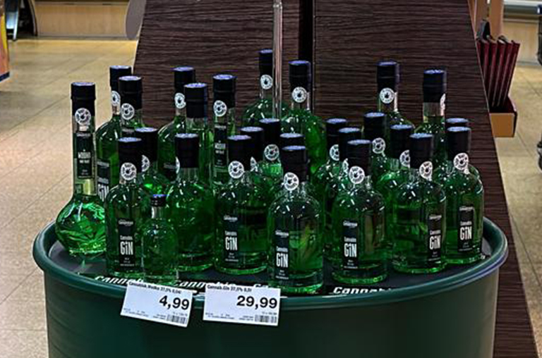 Gin- und Wodkaflaschen von Cannabiskaja auf einem grünen Fass im Markt von EDEKA Höfling